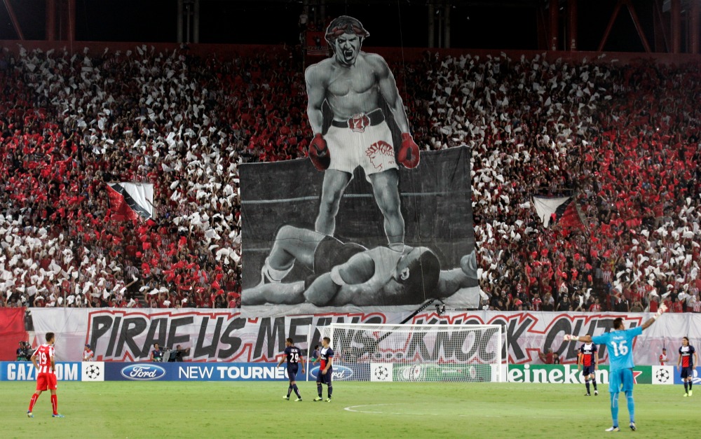 ATHENS, GREECE - SEPTEMBER 17: Olympiacos FC supporters during the UEFA Champions League group stage match between Olympiacos FC and Paris Saint-Germain FC held on September 17, 2013 at the Georgios Karaiskakis Stadium in Athens, Greece. (Photo by Milos Bicanski/EuroFootball/Getty Images)